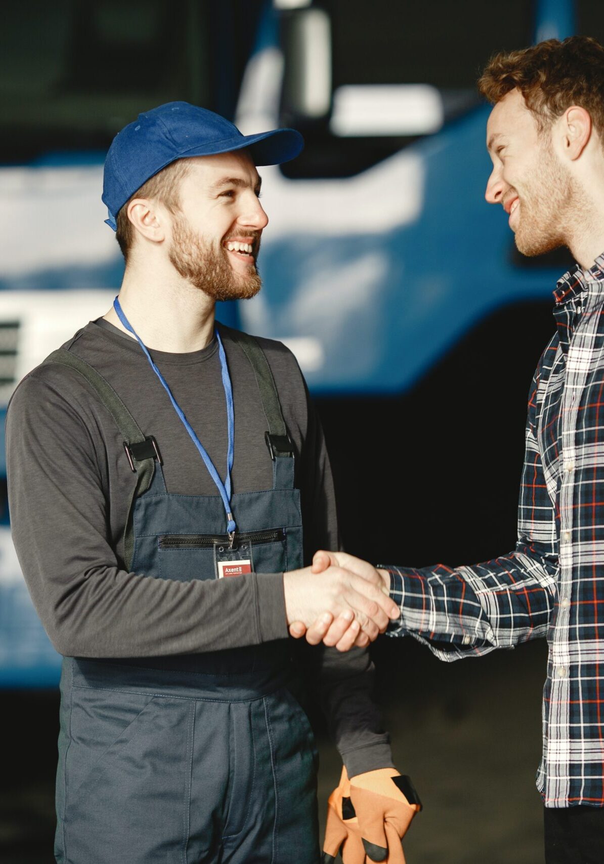 Mechanic and client handshake at an autoshop